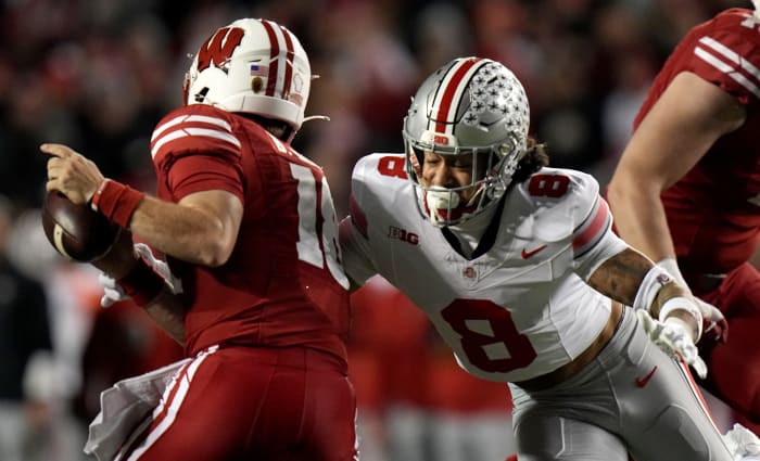 Wisconsin quarterback Braedyn Locke (18) avoids a sack by Ohio State safety Lathan Ransom (8) during the second quarter of their game Saturday, October 28, 2023 at Camp Randall Stadium in Madison, Wisconsin